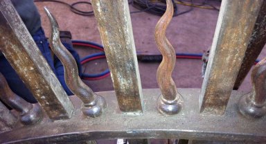 Picture shows ironwork that has been cleaned once and is waiting to be checked over by a second team and cleaned again if necessary. It will then be checked again as it painted in a holding primer by the quality control operative. Areas not up to scratch will be left unpainted and will have to be done again.